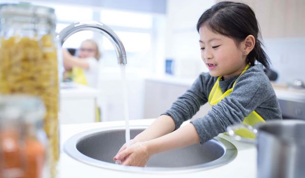 Schoolgirl washes her hands