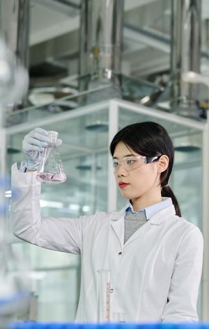Doctor holding up an Erlenmeyer flask - Laboratories and Chemical Industry